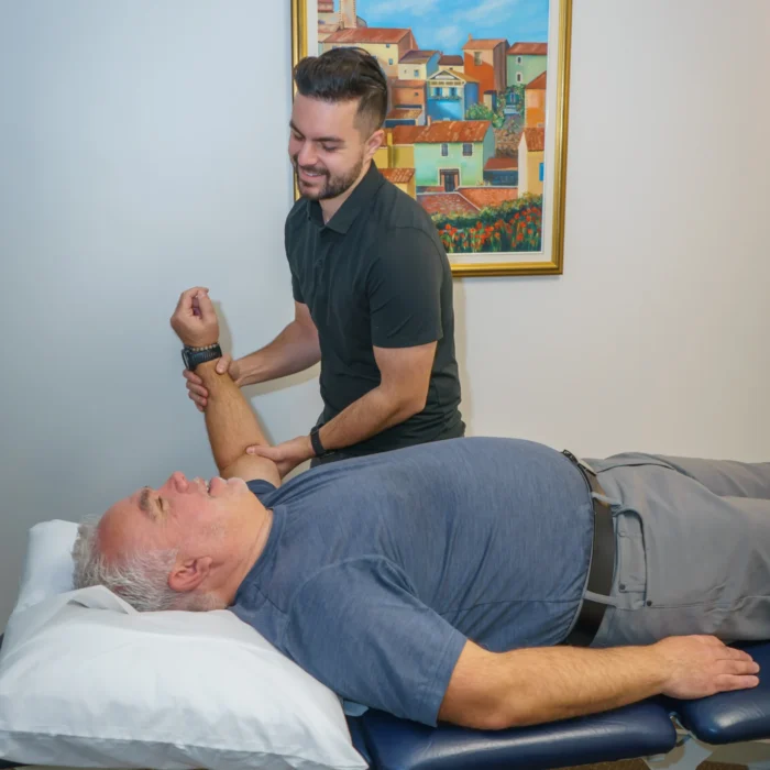 Michael Porreca providing personalized physiotherapy care to a patient in Oakville, focusing on recovery and rehabilitation.