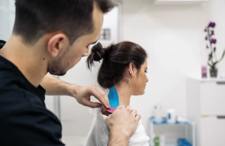 Michael Porreca and Libor Divilek collaborating in a physiotherapy clinic, focusing on patient recovery and care.