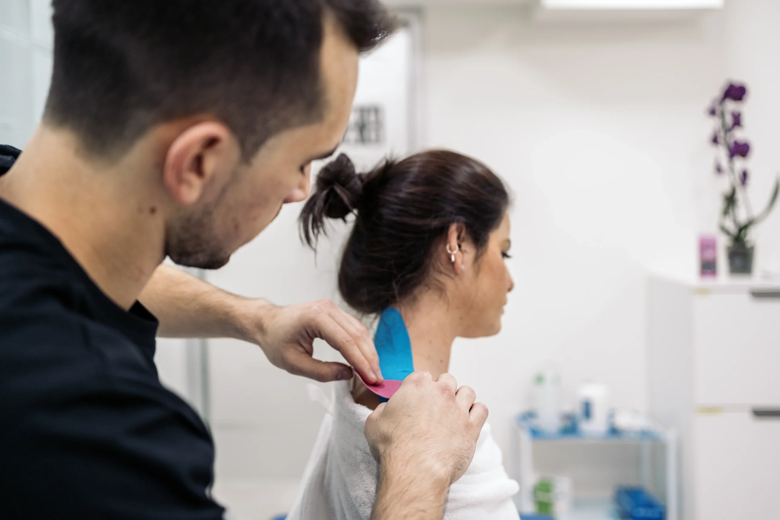 Michael Porreca and Libor Divilek collaborating in a physiotherapy clinic, focusing on patient recovery and care.
