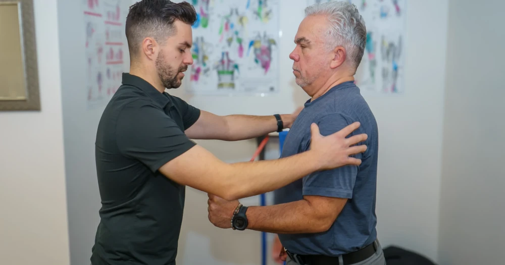 Michael Porreca providing personalized physiotherapy care to patients at Accelerate Physiotherapy in Oakville.
